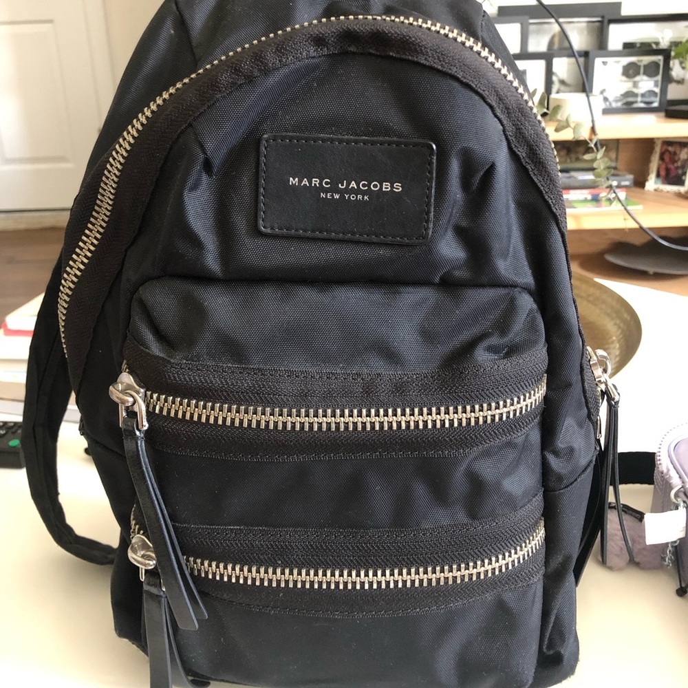 Marc Jacob black bag pack with silver zipper detail.
